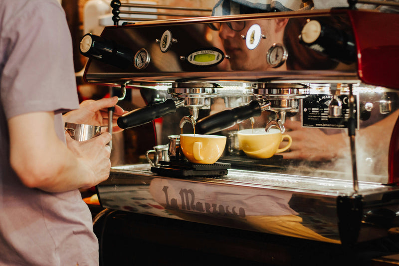 Engineer servicing a commercial espresso coffee machine